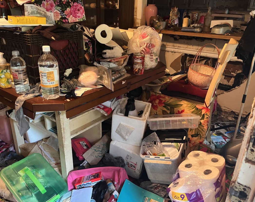 Kitchen and table clutter before an Auburn Hills hoarding cleanout